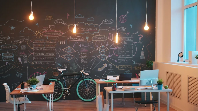 Modern office space with chalkboard wall and bicycles.